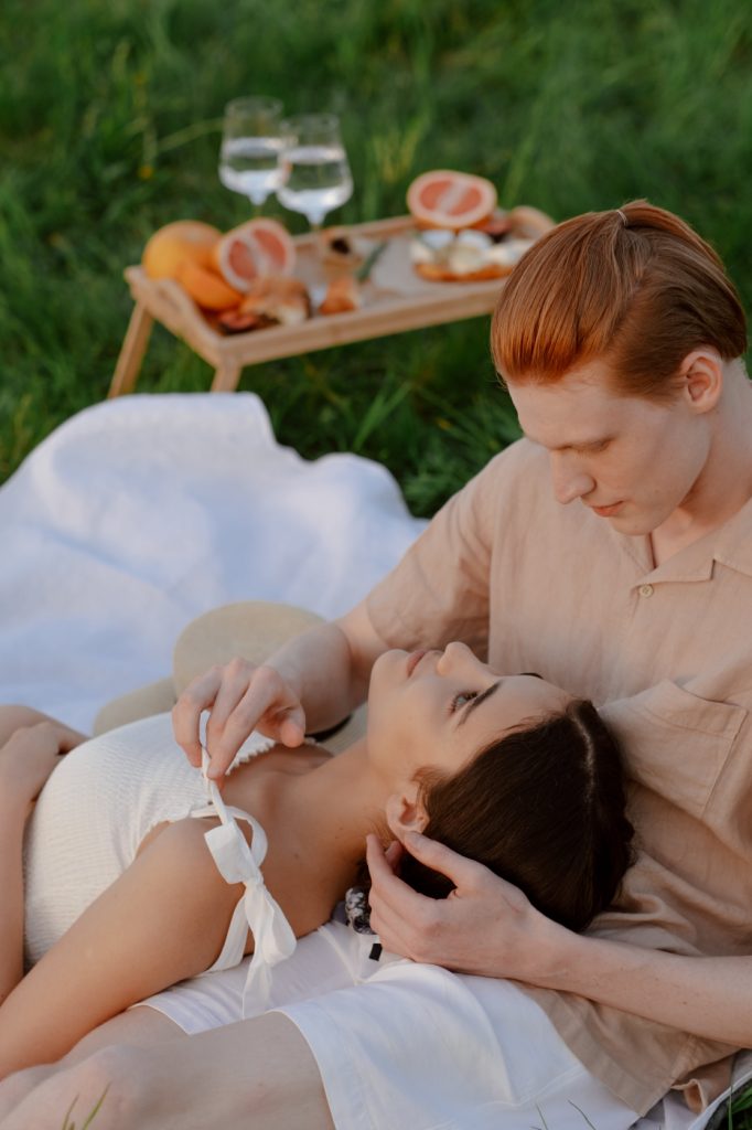 couples laying on the grass