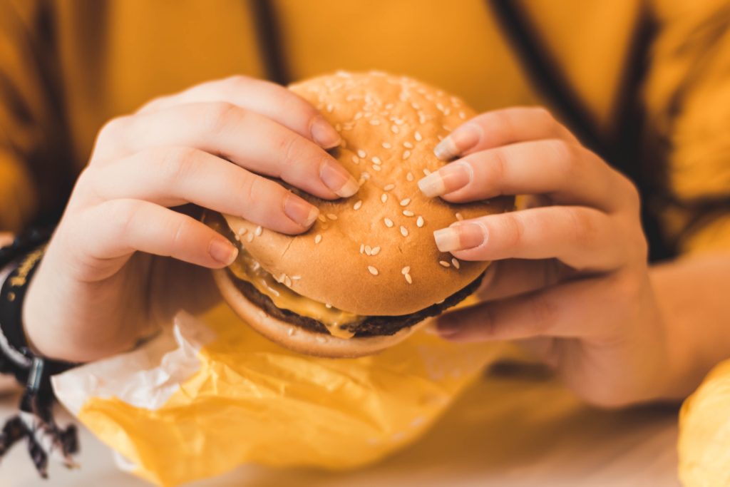 a man holding a big mac burger