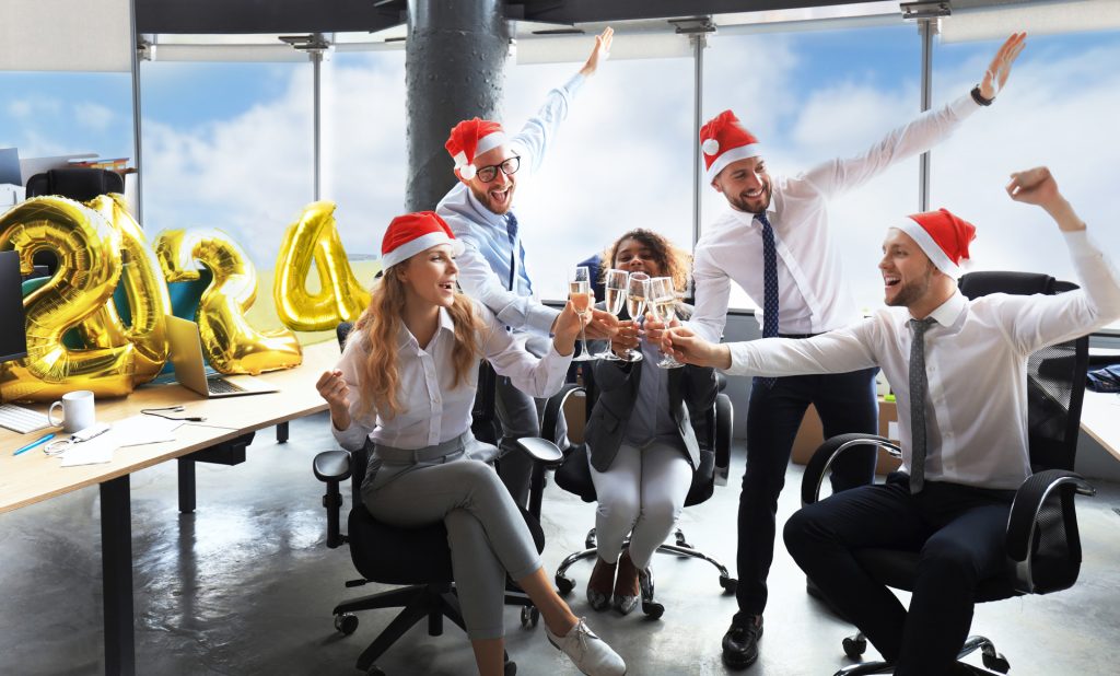 people celebrating christmas and the new years in the office